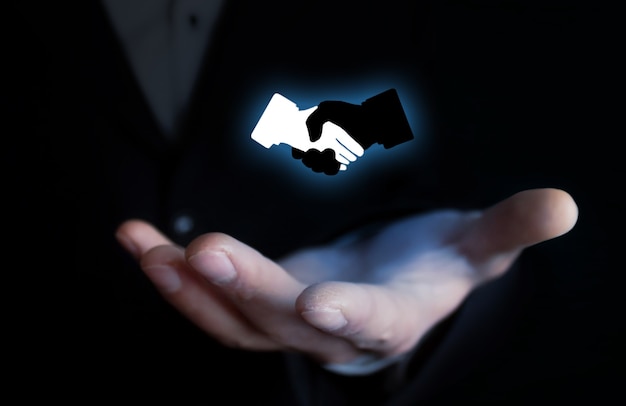 Business handshake symbol on dark blue background