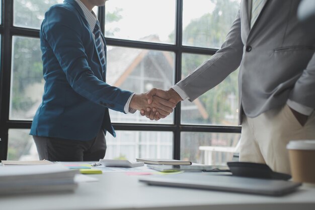 Business handshake for teamwork of business merger and acquisitionsuccessful negotiatehand shaketwo businessman shake hand with partner to celebration partnership and business deal concept