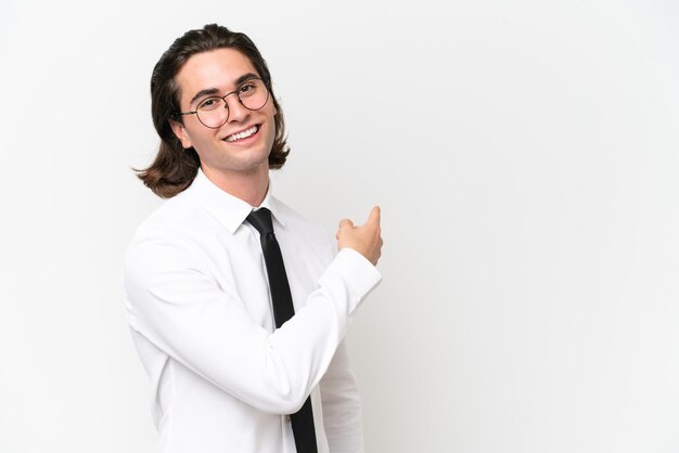 Business handsome man isolated on white background pointing back