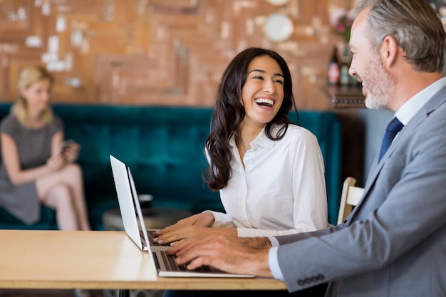 Photo business interacting while using laptop