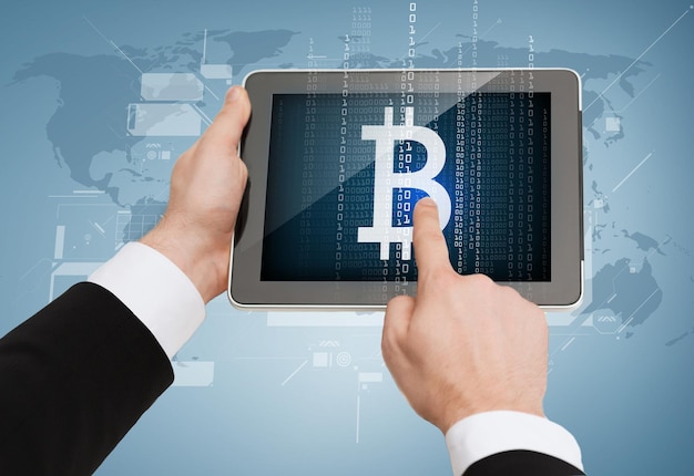 business, internet and technology concept - close up of man hands touching tablet pc with bitcoin symbol