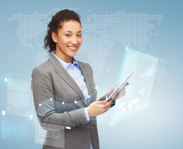 business, internet and technology concept - smiling african-american woman looking at tablet pc computer