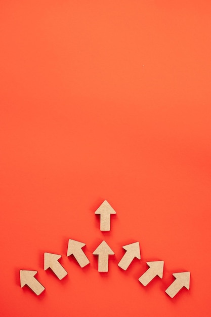 business investment growth concept wooden arrows on red background