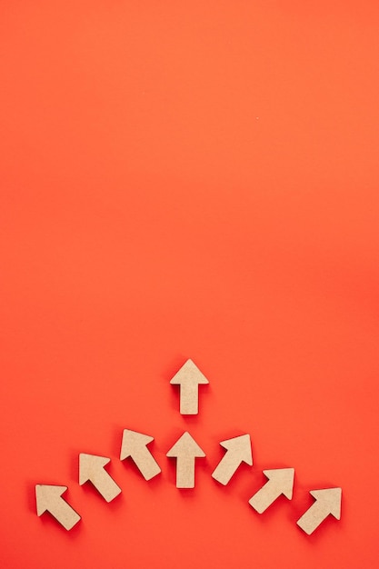 Business investment growth concept Wooden arrows on red background