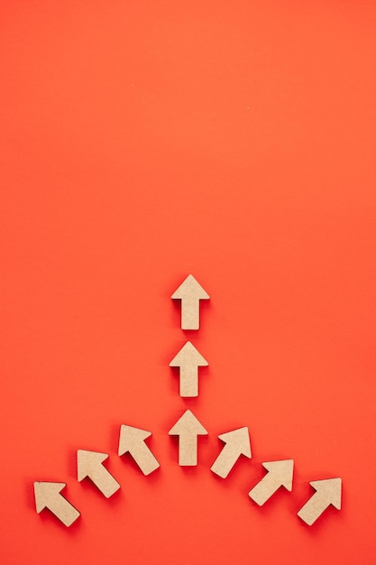 business investment growth concept wooden arrows on red background