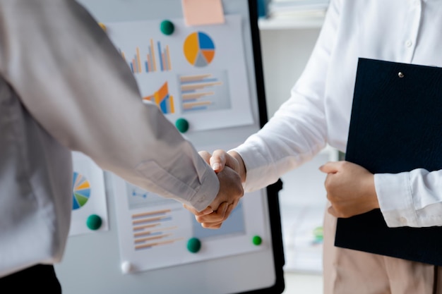 Business investor group holding hands Two businessmen are agreeing on business together and shaking hands after a successful negotiation Handshaking is a Western greeting or congratulation