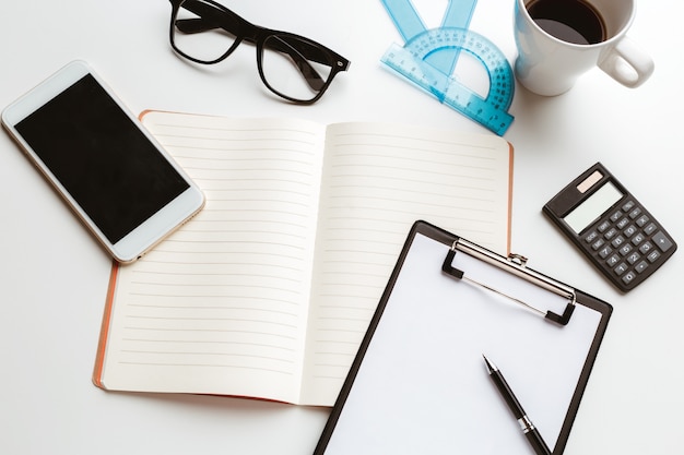 Business Items dropped in creative Disorder on white Table