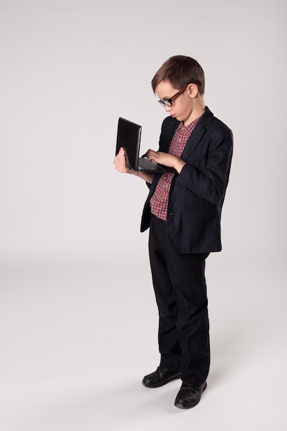 Business kid using wireless internet on laptop