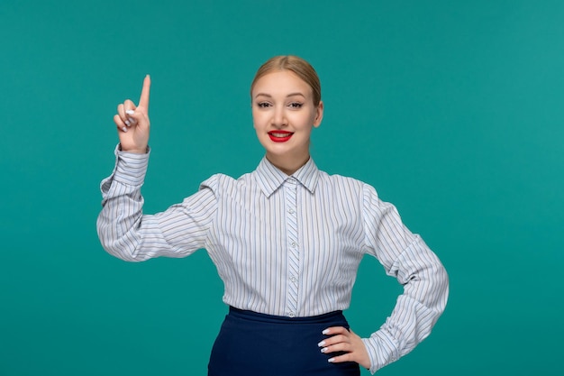 Business lady smiling pretty blonde woman in office outfit pointing up