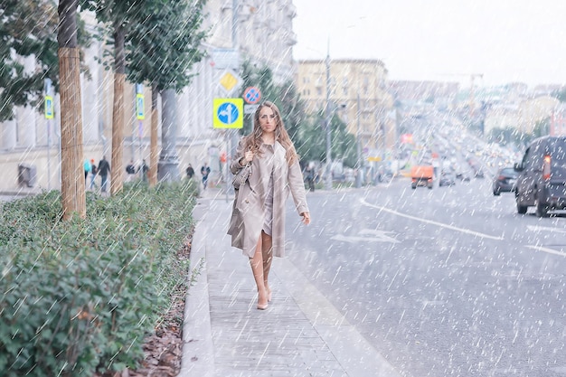 business lady stands road, cars, traffic, urban style, travel in the city, woman and cars