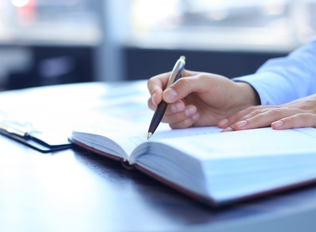 Business lady taking business notes at office