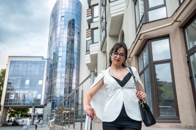 Business lady talking on the phone and looking at the clock to be in time to the office