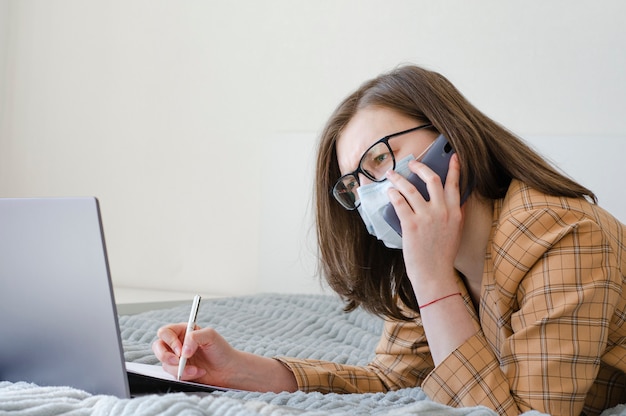 Business lady working at home on her laptop and phone