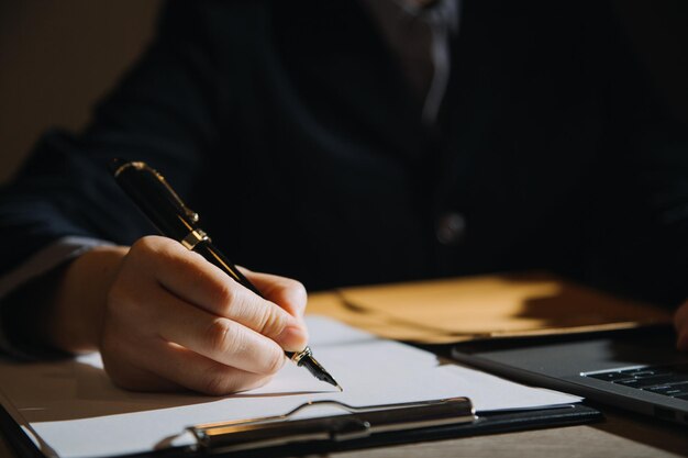 Business and lawyers discussing contract papers with brass\
scale on desk in office law legal services advice justice and law\
concept picture with film grain effect