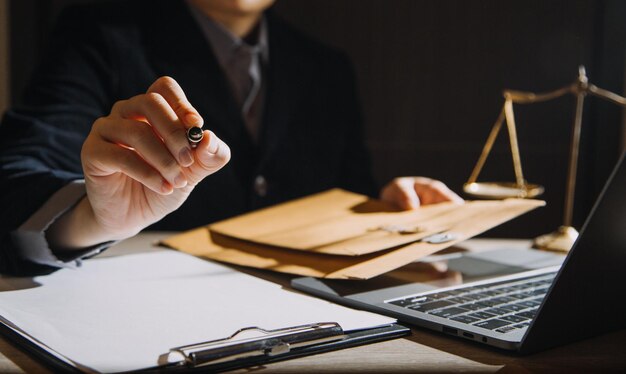 Business and lawyers discussing contract papers with brass\
scale on desk in office law legal services advice justice and law\
concept picture with film grain effect