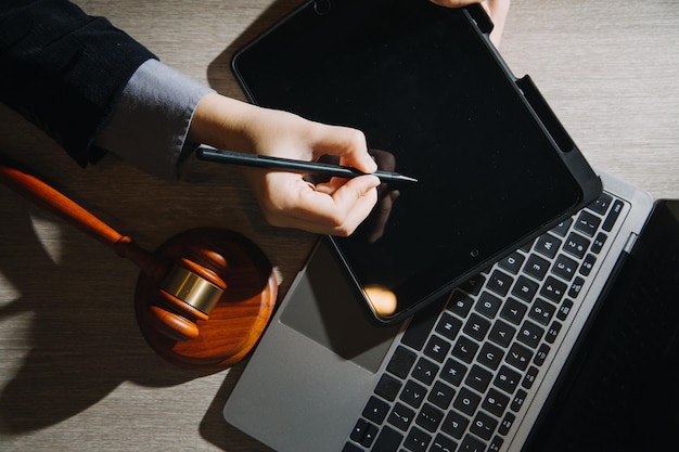 Business and lawyers discussing contract papers with brass
scale on desk in office law legal services advice justice and law
concept picture with film grain effect