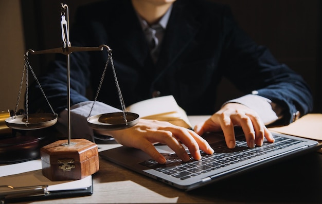 Business and lawyers discussing contract papers with brass
scale on desk in office law legal services advice justice and law
concept picture with film grain effect