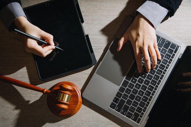 Business and lawyers discussing contract papers with brass\
scale on desk in office law legal services advice justice and law\
concept picture with film grain effect