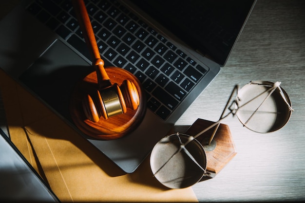 Business and lawyers discussing contract papers with brass scale on desk in office Law legal services advice justice and law concept picture with film grain effect