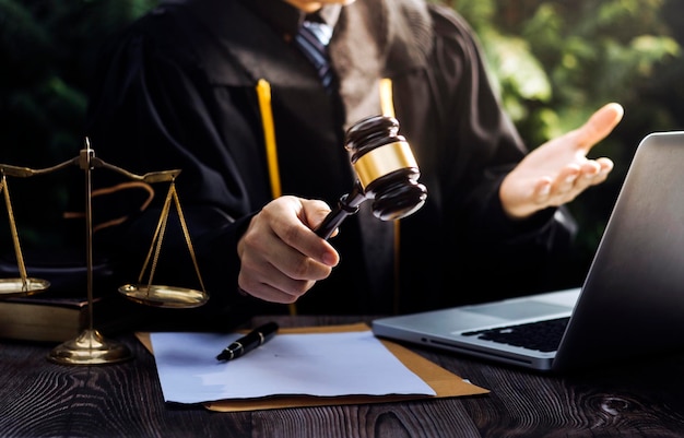 Business and lawyers discussing contract papers with brass scale on desk in office Law legal services advice justice and law concept picture with film grain effect