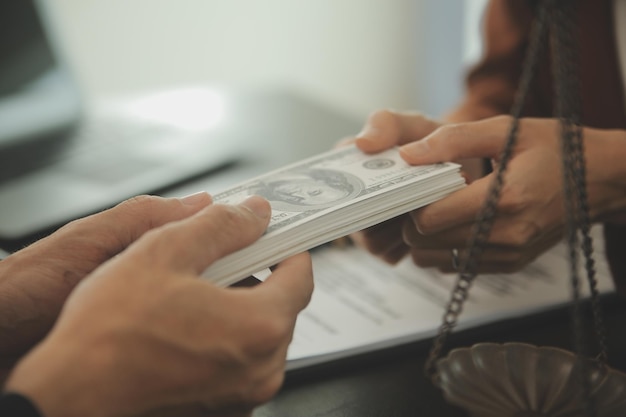 Business and lawyers discussing contract papers with brass scale on desk in office Law legal services advice justice and law concept picture with film grain effect