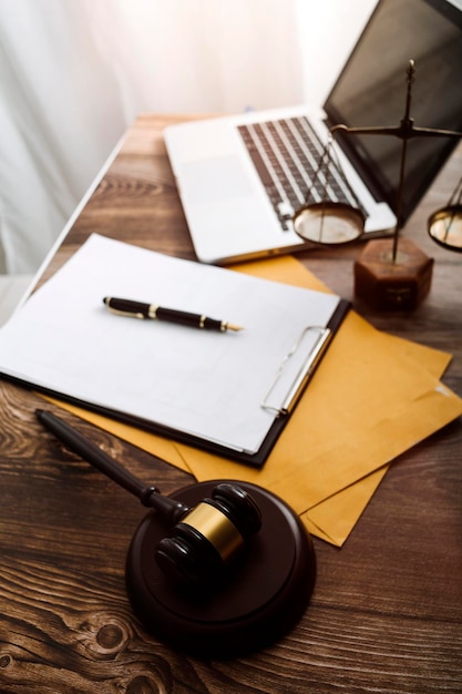 Business and lawyers discussing contract papers with brass scale on desk in office Law legal services advice justice and law concept picture with film grain effect