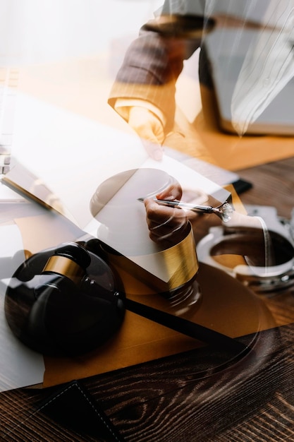 Business and lawyers discussing contract papers with brass scale on desk in office Law legal services advice justice and law concept picture with film grain effect