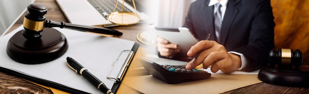 Business and lawyers discussing contract papers with brass scale on desk in office Law legal services advice justice and law concept picture with film grain effect