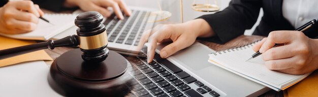 Business and lawyers discussing contract papers with brass scale on desk in office Law legal services advice justice and law concept picture with film grain effect