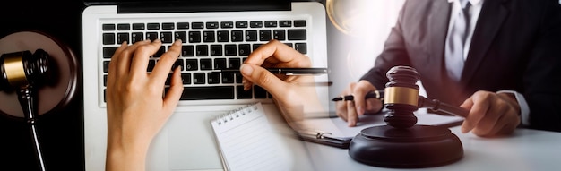 Business and lawyers discussing contract papers with brass scale on desk in office Law legal services advice justice and law concept picture with film grain effect