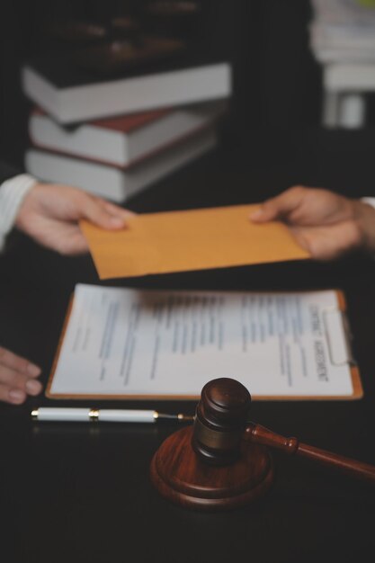 Business and lawyers discussing contract papers with brass scale on desk in office Law legal services advice justice and law concept picture with film grain effect