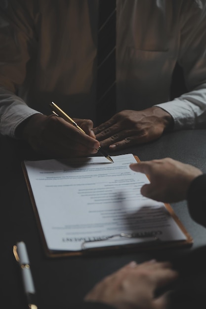 Business and lawyers discussing contract papers with brass scale on desk in office Law legal services advice justice and law concept picture with film grain effect