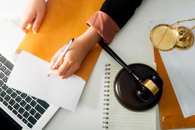 Business and lawyers discussing contract papers with brass scale on desk in office Law legal services advice justice and law concept picture with film grain effect