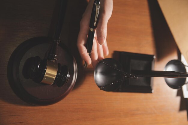 Business and lawyers discussing contract papers with brass scale on desk in office Law legal services advice justice and law concept picture with film grain effect