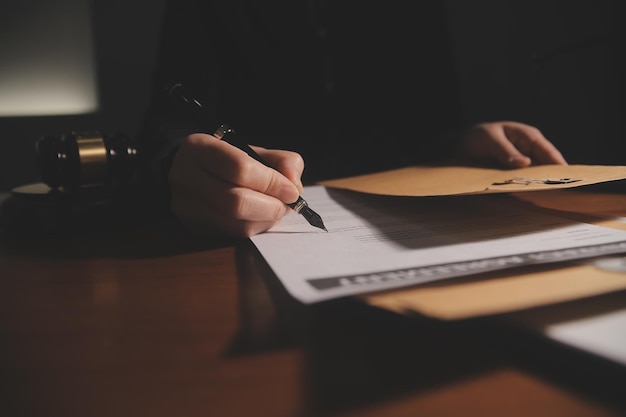 Business and lawyers discussing contract papers with brass scale on desk in office Law legal services advice justice and law concept picture with film grain effect