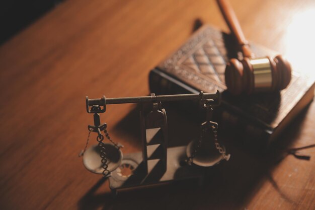 Business and lawyers discussing contract papers with brass scale on desk in office Law legal services advice justice and law concept picture with film grain effect