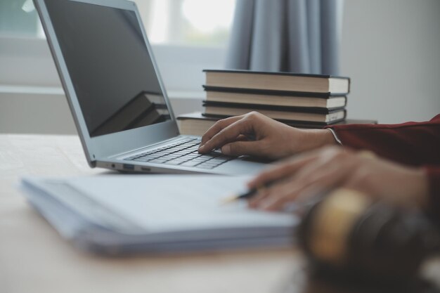 Business and lawyers discussing contract papers with brass scale on desk in office Law legal services advice justice and law concept picture with film grain effect