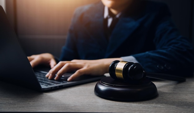 Business and lawyers discussing contract papers with brass scale on desk in office Law legal services advice justice and law concept picture with film grain effect