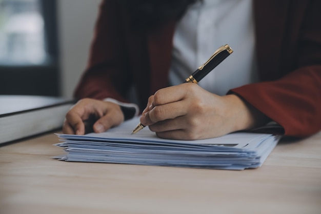 Business and lawyers discussing contract papers with brass scale on desk in office Law legal services advice justice and law concept picture with film grain effect