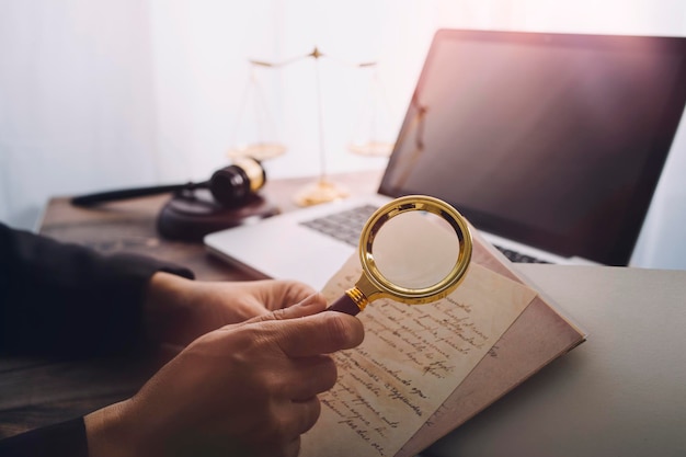 Business and lawyers discussing contract papers with brass scale on desk in office Law legal services advice justice and law concept picture with film grain effect