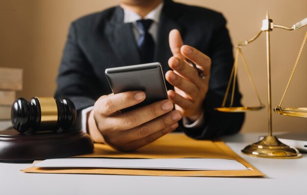 Business and lawyers discussing contract papers with brass scale on desk in office Law legal services advice justice and law concept picture with film grain effect