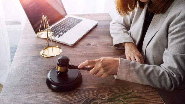 Business and lawyers discussing contract papers with brass scale on desk in office Law legal services advice justice and law concept picture with film grain effect