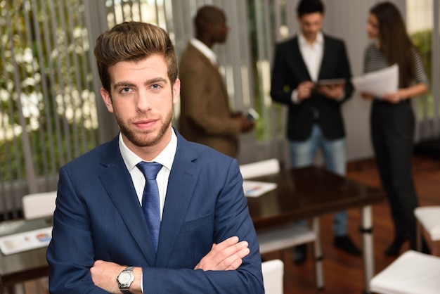 Business leader looking at camera in working environment 