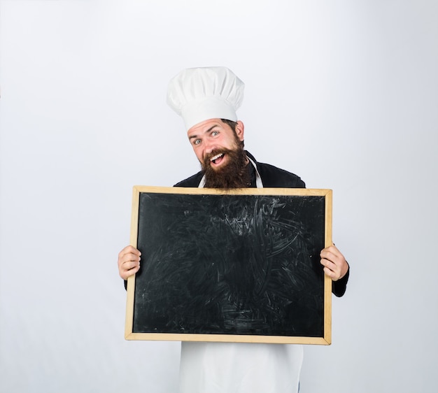 Business lunch menu blank chalkboard with copy space for text bearded chef holds blackboard