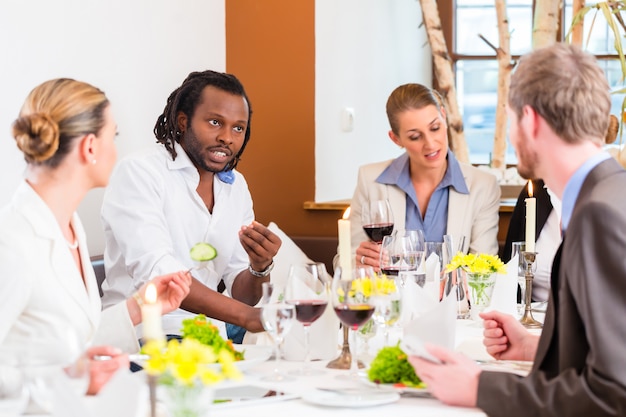 Business lunch in restaurant with food and wine