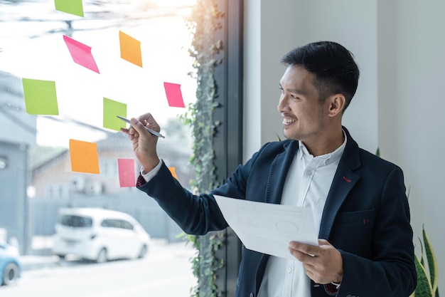 Business male write on colorful sticky notes develop business project in office business male brainstorm engaged in creative thinking make startup plan