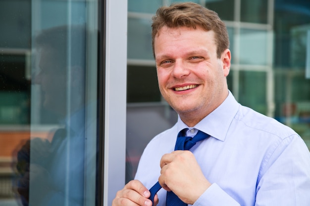 Business man  adjusting tie