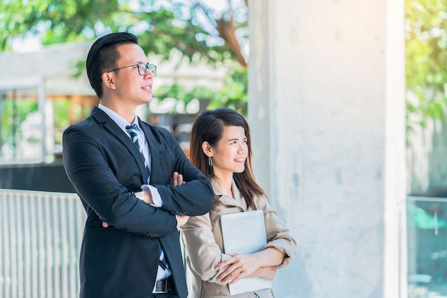 Business man in the black suit and the business woman waiting for the customer.