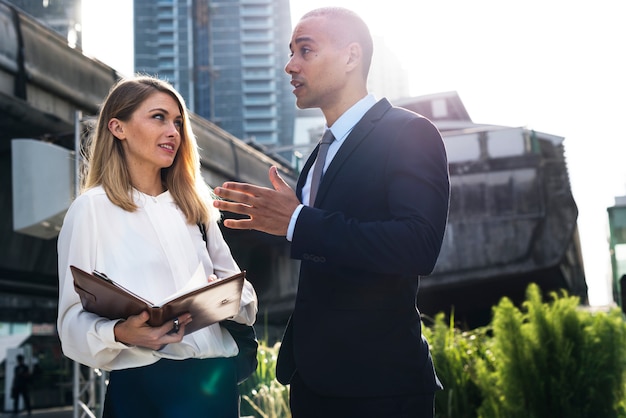 Business man and business woman talking outdoors