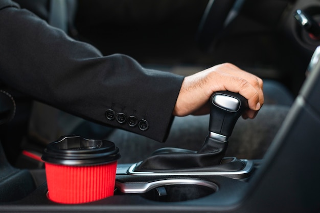 Business man in the car changing the gears